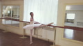 Slim ballerina exercising at the barre in studio, slow motion Video