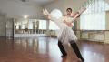 Positive elegant couple dancing ballet in studio, slow motion Video