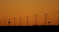 Telephone poles at dusk with orange sky. Saskatchewan, Canada. Footage