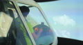 Male pilot learning to navigate aircraft in flight simulator, playing video game Footage