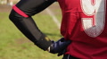 Back view of reserve player watching American football match from sidelines Footage