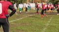 Rival football team players taking positions on scrimmage line before snap Footage
